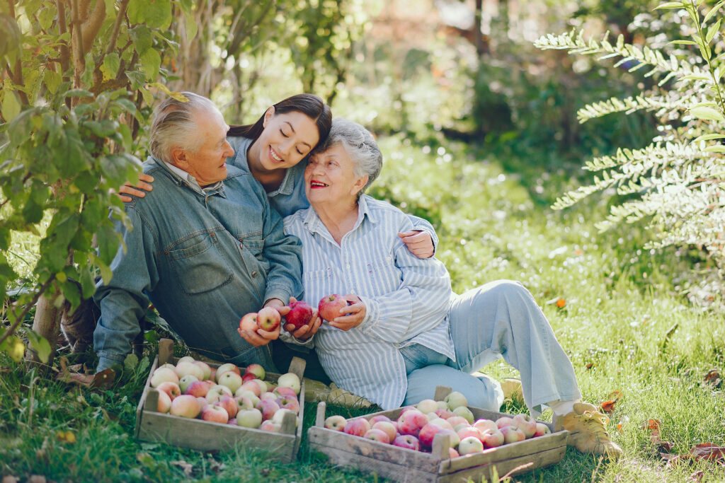 family sitting garden with apples