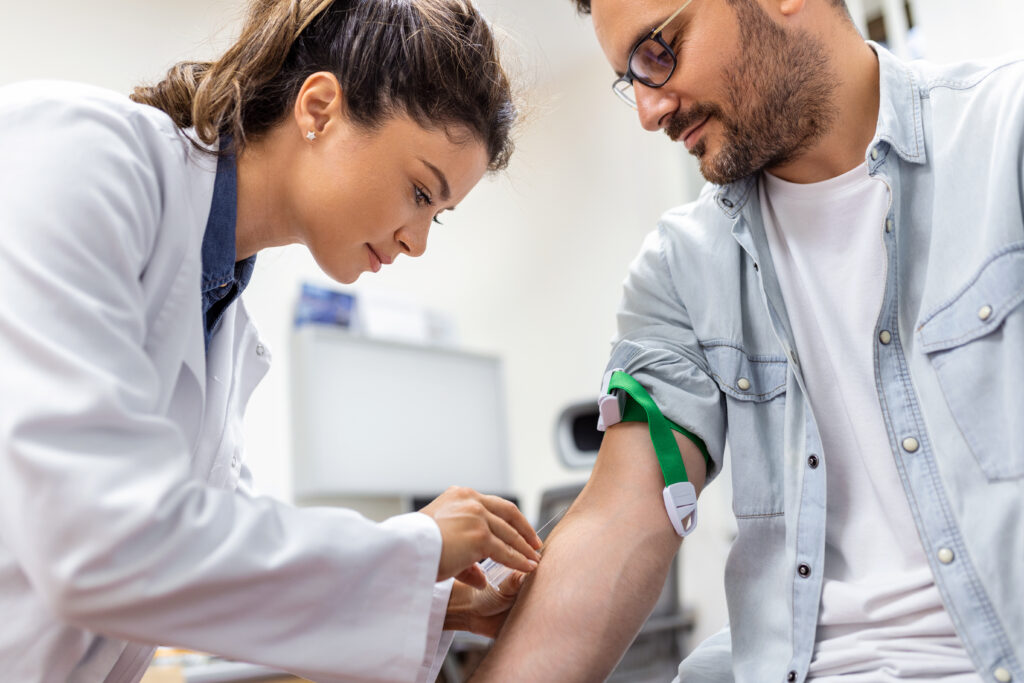 friendly hospital phlebotomist collecting blood sample from patient lab preparation blood test by female doctor medical uniform table white bright room