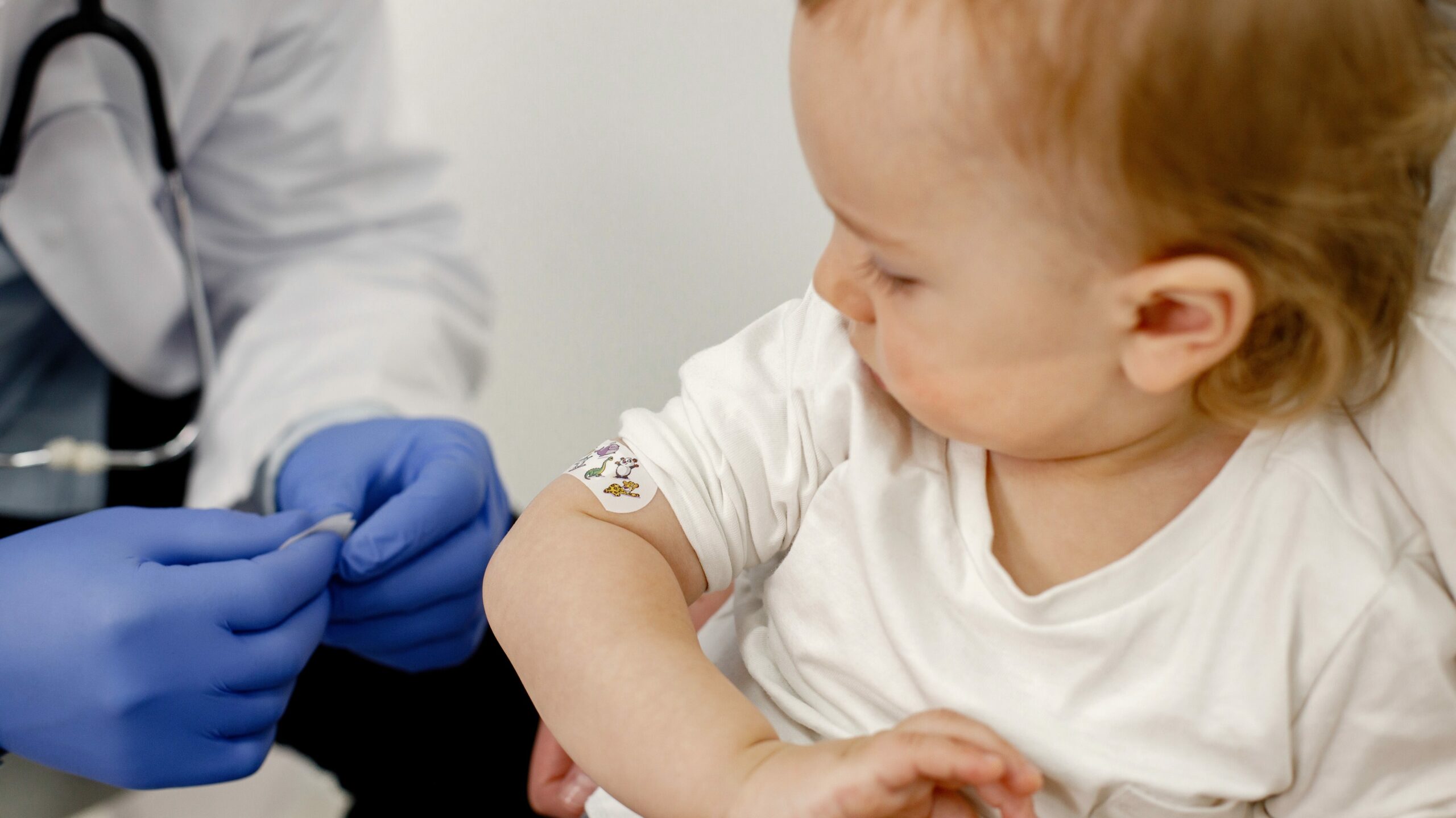 cropped photo boy s shoulder with stick bandaid vaccination edited scaled