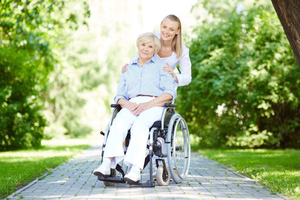 nurse walking with senior patient wheelchair