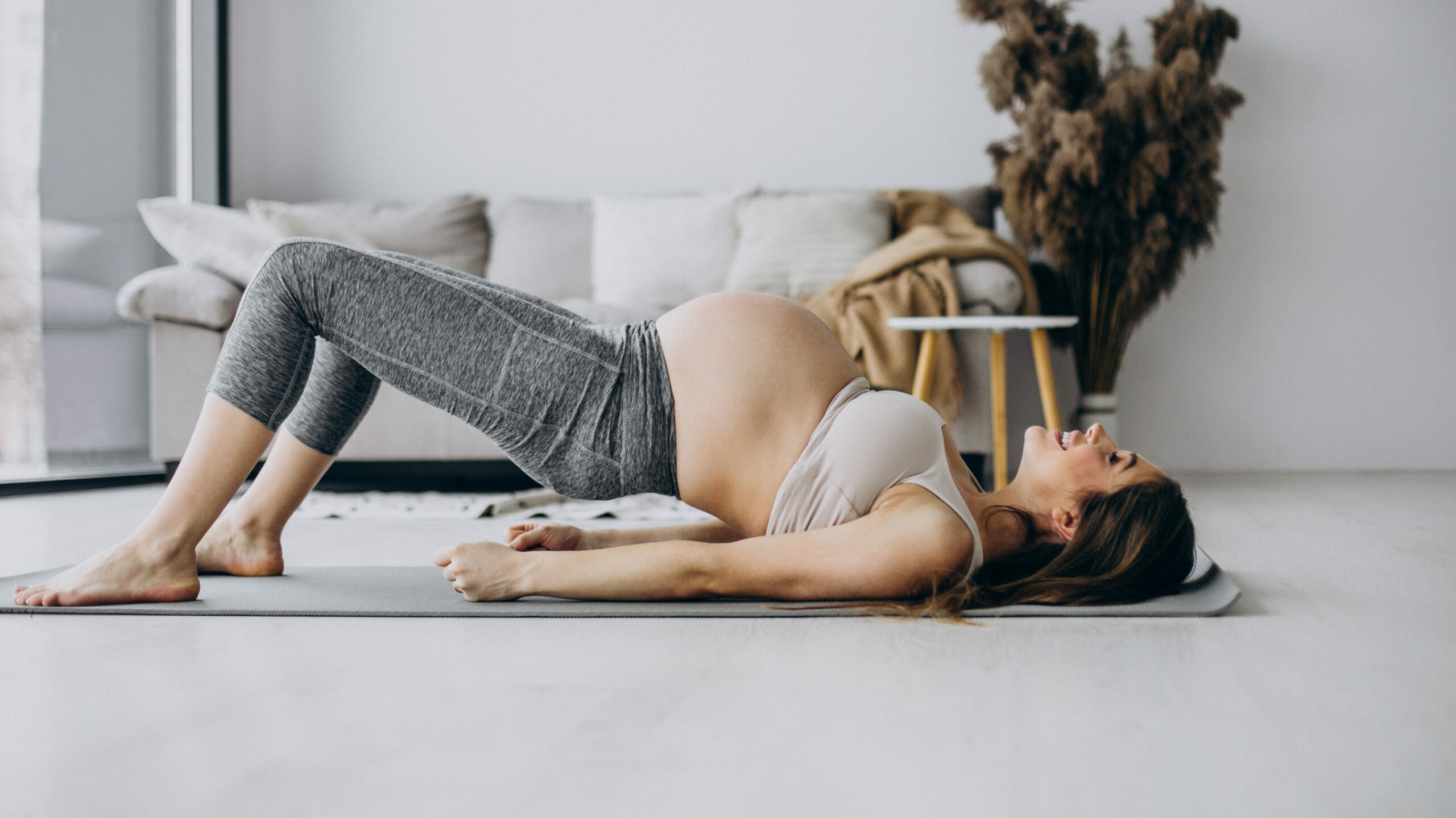 pregnant woman practicing yoga mat home edited scaled